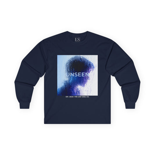 Front mockup of “UNSEEN” long sleeve navy tee silhouette behind wet glass in blue tones with brand name below.