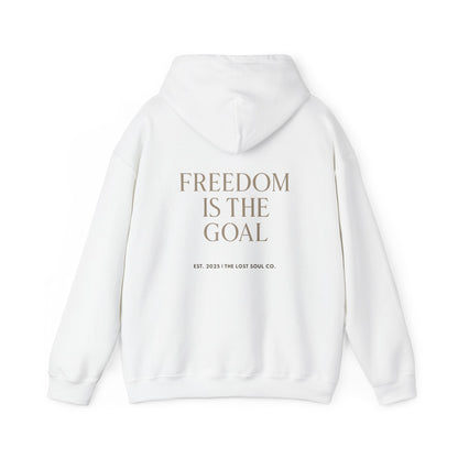 Back of white hoodie with bold serif quote “FREEDOM IS THE GOAL” and subtle brand signature – The Lost Soul Co.