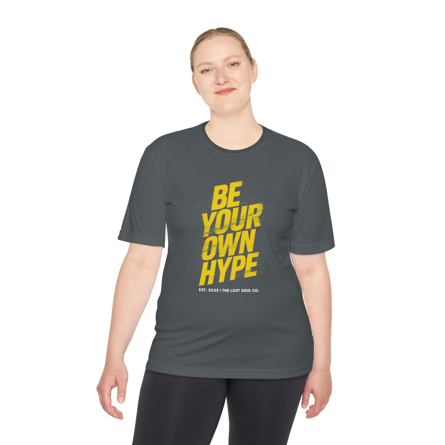 Person wearing gym t-shirt by The Lost Soul Co. with yellow ‘BE YOUR OWN HYPE’ design and angled motion streaks